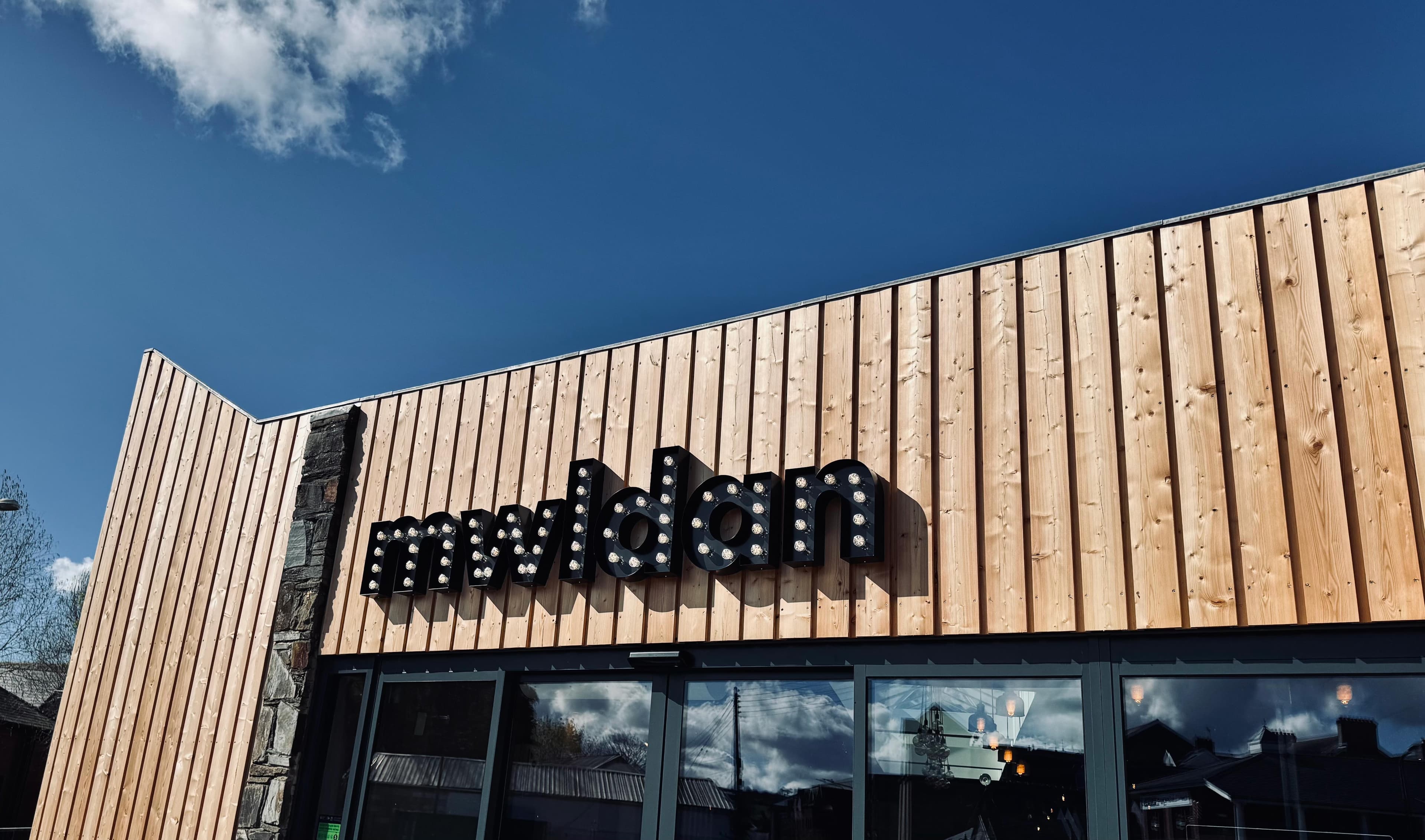 front of building with mwldan sign