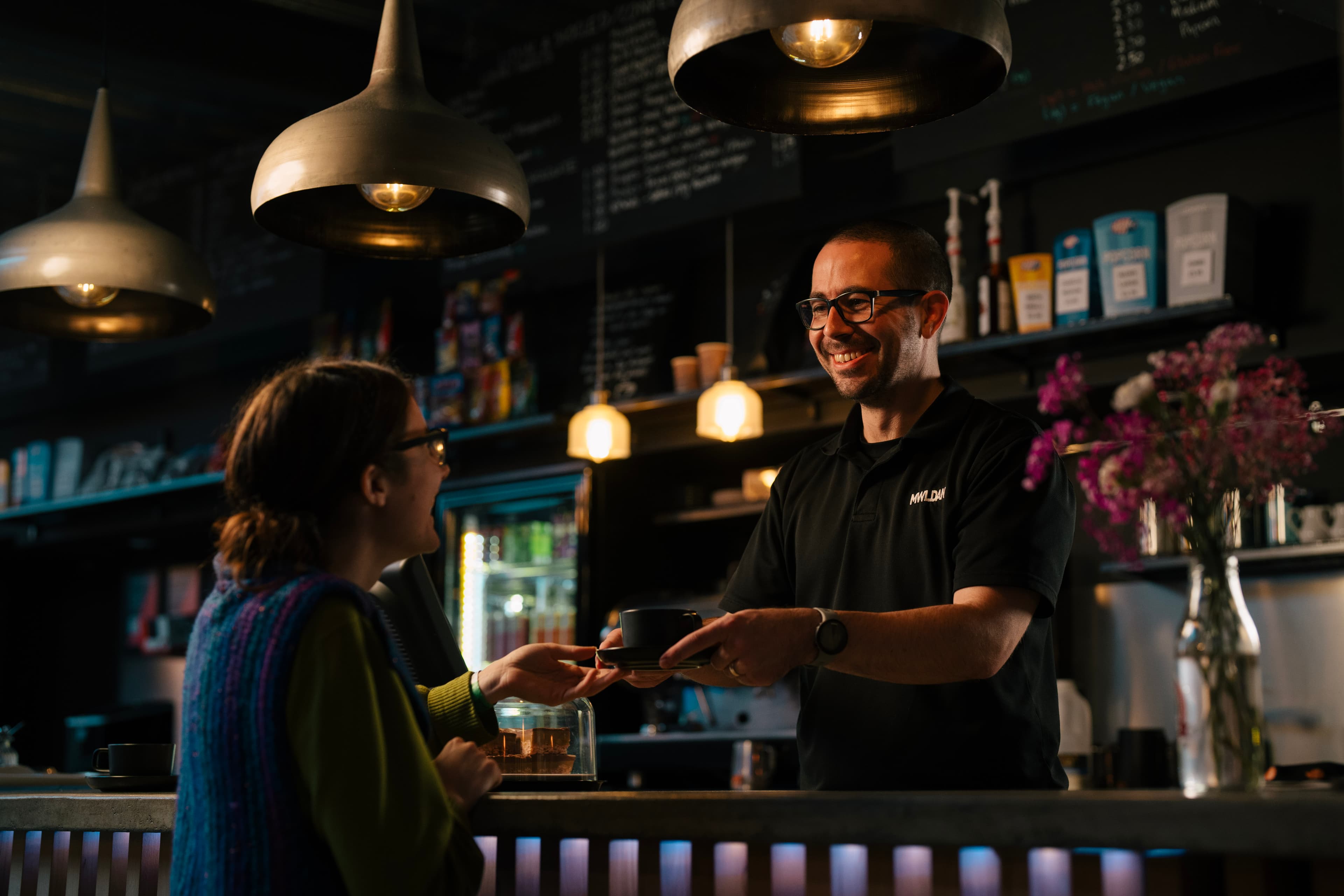 Mike serving Taryn at the bar