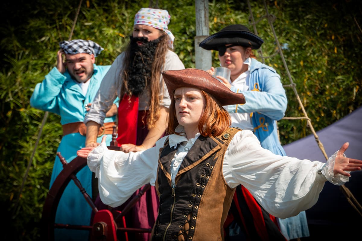 Illyria outdoor theatre production of the Pirates of Penzance, four actors in pirate costume on stage